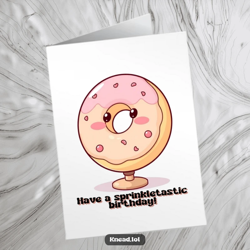 Funny Free Printable Birthday Card: A blushing, plump donut with dot eyes spins on a stand, celebrating a birthday.